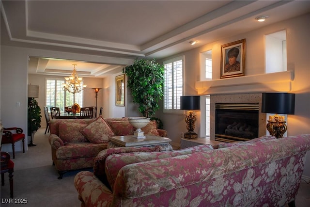 9905 Fox Springs Dr, Las Vegas, NV 89117 - carpeted living area with a tray ceiling, a chandelier, and a fireplace