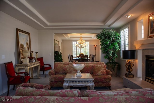 9905 Fox Springs Dr, Las Vegas, NV 89117 - living room with a tray ceiling, a chandelier, carpet flooring, and a fireplace