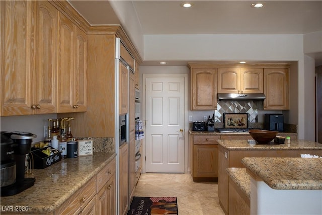 9905 Fox Springs Dr, Las Vegas, NV 89117 - kitchen with recessed lighting, tasteful backsplash, light stone counters, under cabinet range hood, and appliances with stainless steel finishes