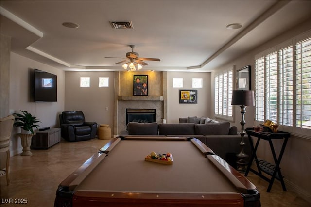 9905 Fox Springs Dr, Las Vegas, NV 89117 - recreation room with pool table, a raised ceiling, a large fireplace, ceiling fan, and healthy amount of natural light