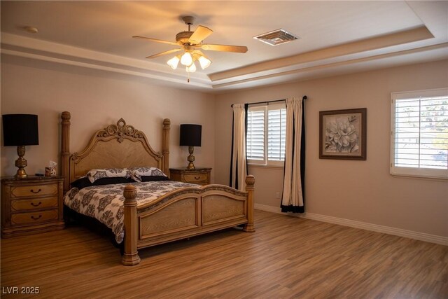 9905 Fox Springs Dr, Las Vegas, NV 89117 - bedroom with a raised ceiling, light wood-style floors, baseboards, and ceiling fan