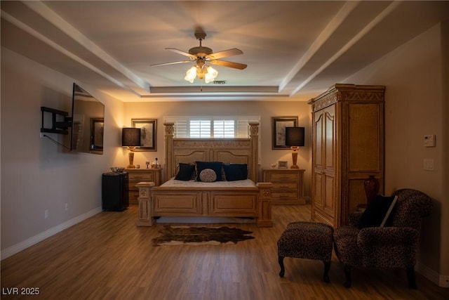 9905 Fox Springs Dr, Las Vegas, NV 89117 - bedroom with a tray ceiling, light wood-style flooring, and baseboards