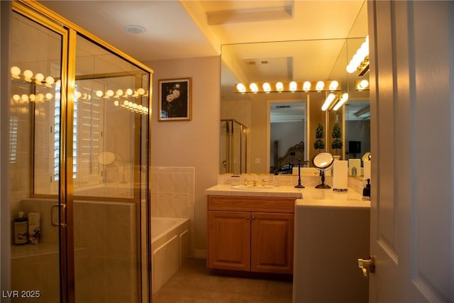 9905 Fox Springs Dr, Las Vegas, NV 89117 - bathroom with a shower stall, a garden tub, vanity, and tile patterned flooring