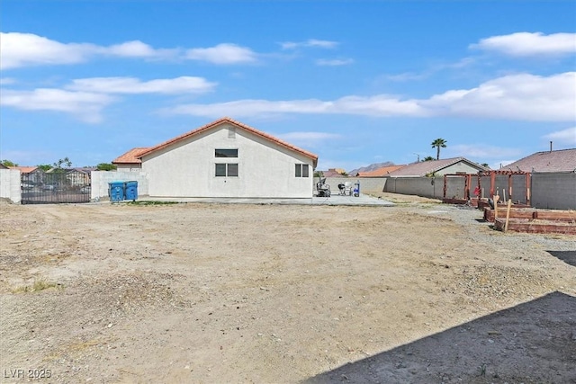 2805 El Cubano Ct, North Las Vegas, NV 89030 - back of property featuring a gate, stucco siding, and fence