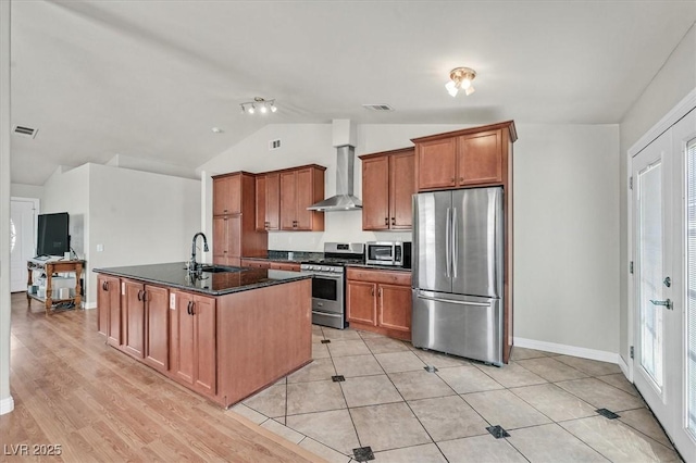 2805 El Cubano Ct, North Las Vegas, NV 89030 - kitchen with visible vents, appliances with stainless steel finishes, a sink, lofted ceiling, and wall chimney exhaust hood