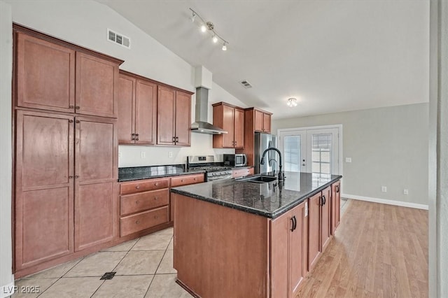 2805 El Cubano Ct, North Las Vegas, NV 89030 - kitchen with appliances with stainless steel finishes, a sink, wall chimney exhaust hood, lofted ceiling, and visible vents