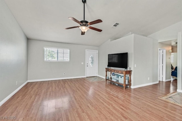 2805 El Cubano Ct, North Las Vegas, NV 89030 - unfurnished living room with visible vents, wood finished floors, baseboards, a ceiling fan, and vaulted ceiling