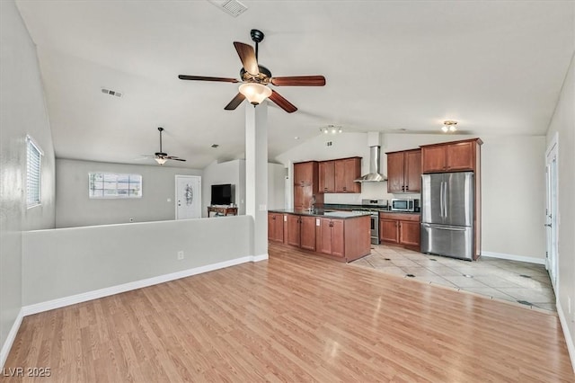 2805 El Cubano Ct, North Las Vegas, NV 89030 - kitchen with wall chimney range hood, dark countertops, appliances with stainless steel finishes, open floor plan, and lofted ceiling