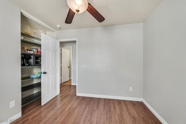 2805 El Cubano Ct, North Las Vegas, NV 89030 - unfurnished bedroom featuring baseboards, a ceiling fan, and wood finished floors