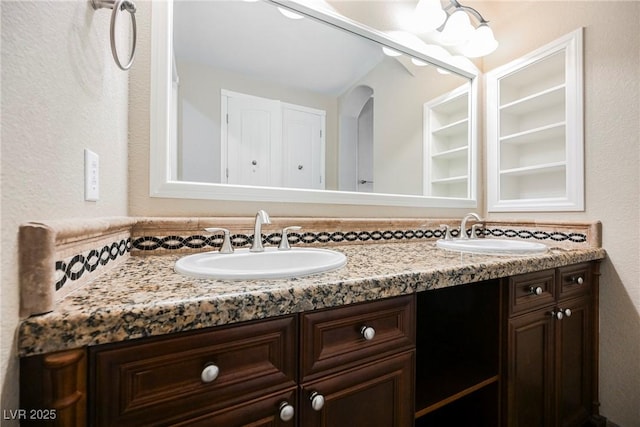 full bath featuring double vanity and a sink
