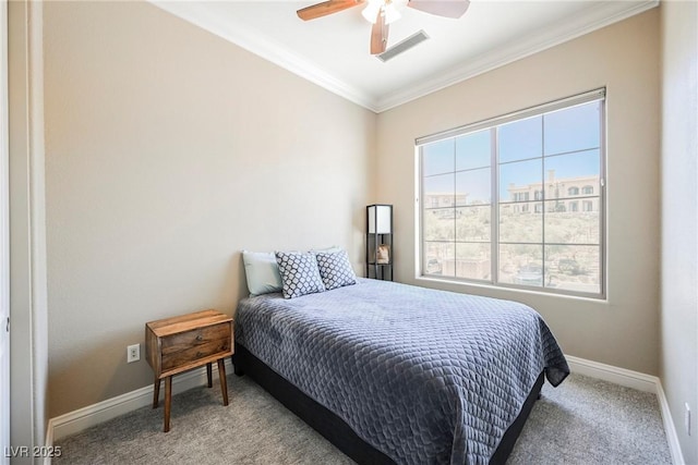 carpeted bedroom featuring baseboards, visible vents, ceiling fan, and crown molding