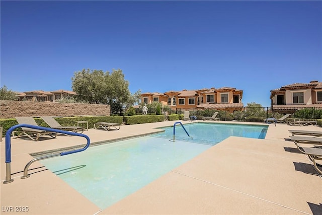 view of swimming pool with a patio, fence, and a fenced in pool