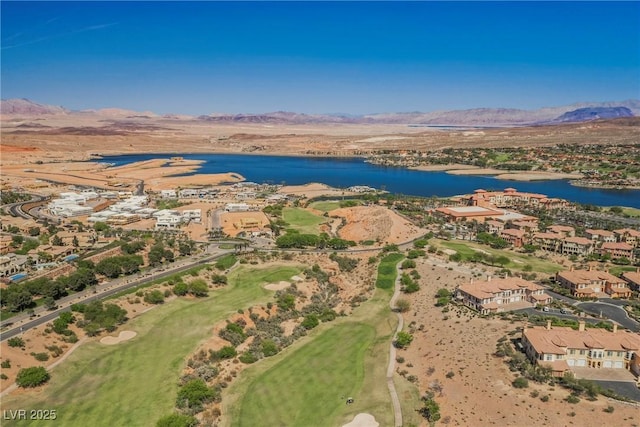 drone / aerial view with golf course view and a water and mountain view