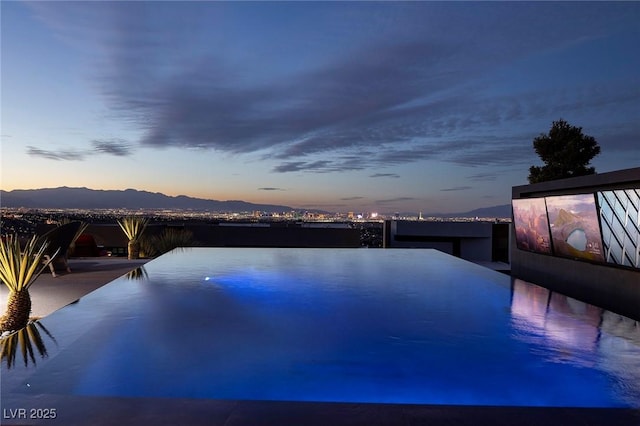 811 Magnum Cliff Ct, Henderson, NV 89012 - pool at dusk featuring a mountain view