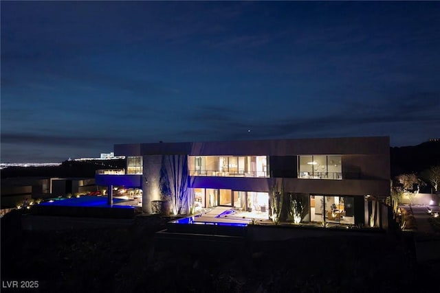 811 Magnum Cliff Ct, Henderson, NV 89012 - back of house at twilight with a balcony