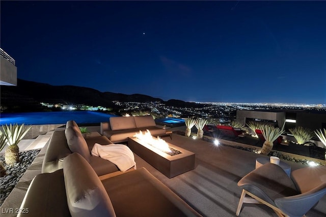 811 Magnum Cliff Ct, Henderson, NV 89012 - patio at twilight with an outdoor living space with a fire pit
