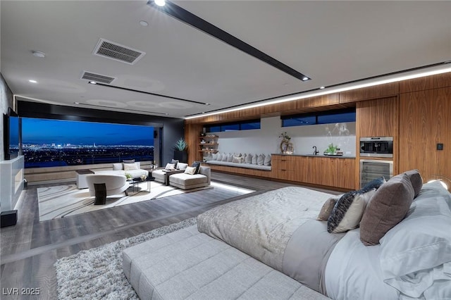 811 Magnum Cliff Ct, Henderson, NV 89012 - cinema with a sink, visible vents, and wood finished floors