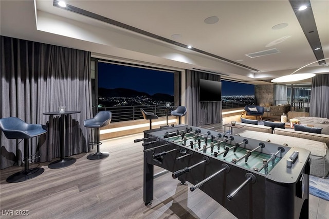 811 Magnum Cliff Ct, Henderson, NV 89012 - rec room with visible vents and wood finished floors
