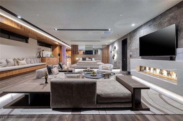 811 Magnum Cliff Ct, Henderson, NV 89012 - living room with visible vents, a multi sided fireplace, and wood finished floors