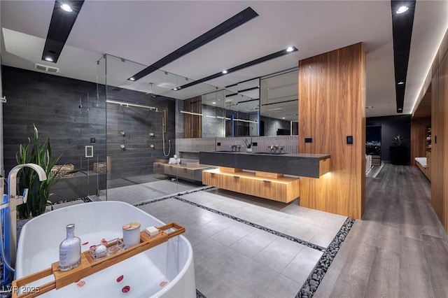 811 Magnum Cliff Ct, Henderson, NV 89012 - full bathroom featuring vanity, visible vents, decorative backsplash, a shower stall, and a freestanding bath