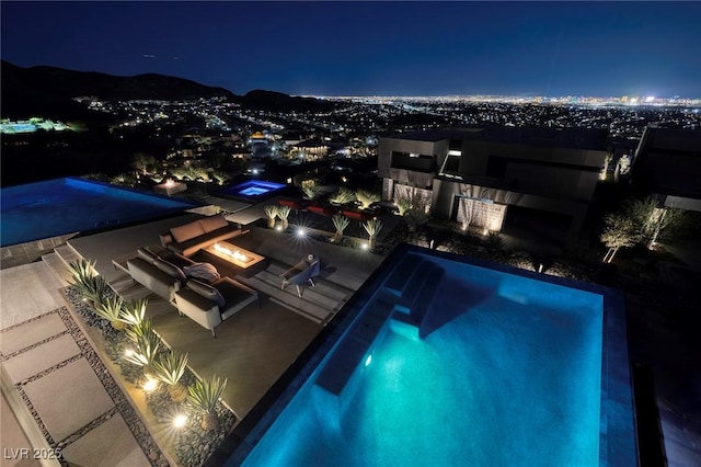 811 Magnum Cliff Ct, Henderson, NV 89012 - pool at twilight featuring an outdoor fire pit, a patio area, and an outdoor pool