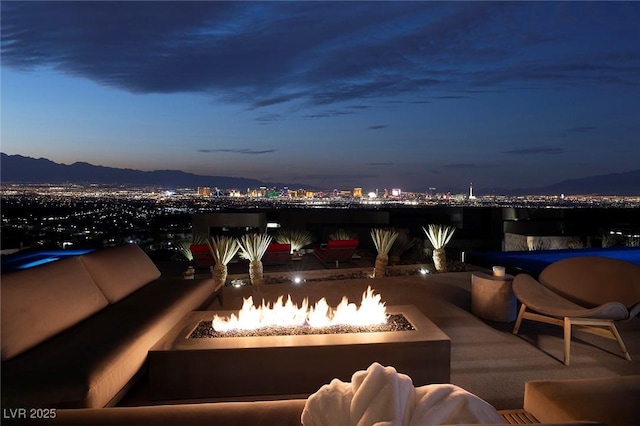 811 Magnum Cliff Ct, Henderson, NV 89012 - view of patio featuring a view of city lights, a fire pit, and a mountain view