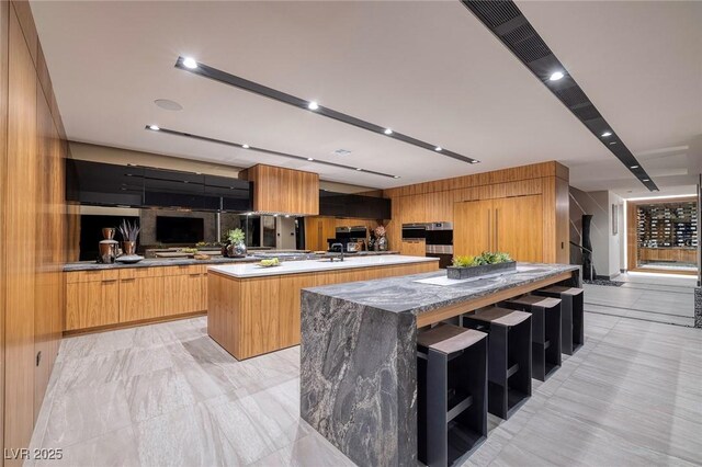 811 Magnum Cliff Ct, Henderson, NV 89012 - kitchen featuring a center island with sink and modern cabinets
