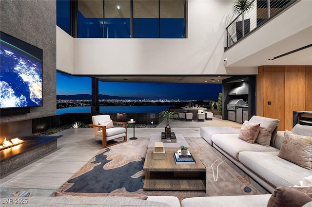 811 Magnum Cliff Ct, Henderson, NV 89012 - living room with a warm lit fireplace and a towering ceiling