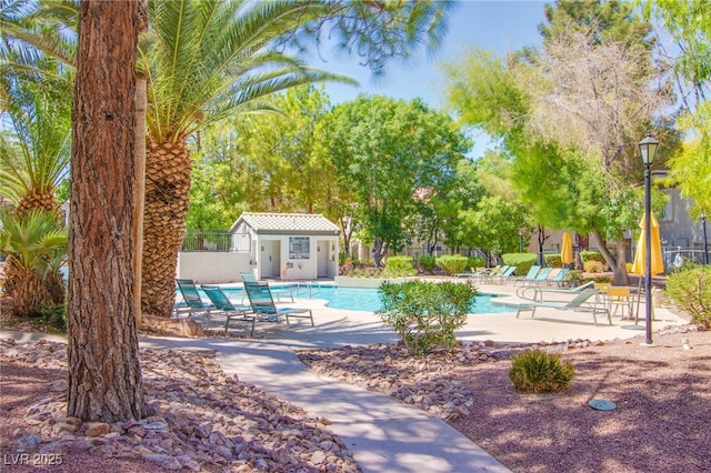 pool featuring fence and a patio