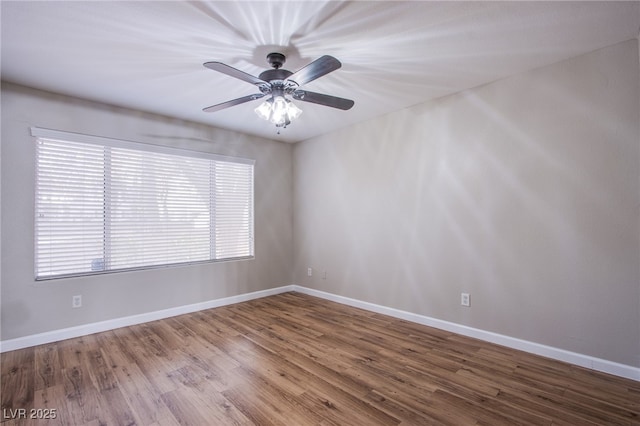 unfurnished room with baseboards, wood finished floors, and ceiling fan