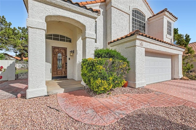 9921 Heffner Hills Cir, Las Vegas, NV 89117 - entrance to property featuring a garage, stucco siding, driveway, and a tile roof