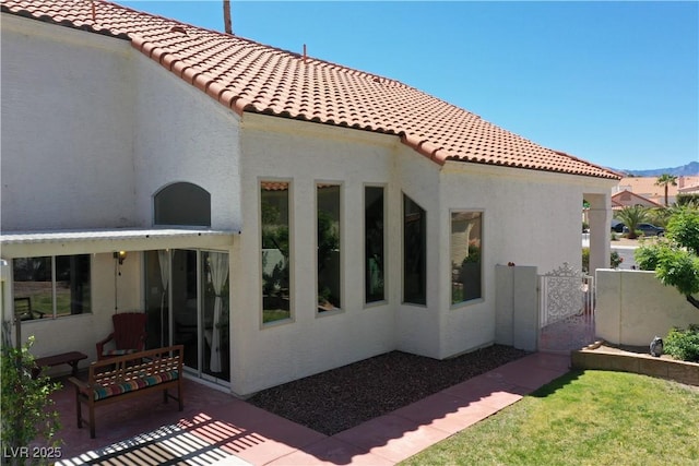 9921 Heffner Hills Cir, Las Vegas, NV 89117 - rear view of house with a gate, a patio area, stucco siding, and a tiled roof