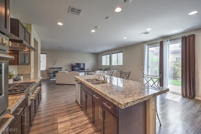 kitchen featuring recessed lighting, a sink, dark wood-style flooring, and visible vents