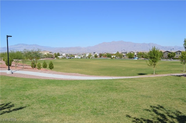 surrounding community with a residential view, a mountain view, and a lawn