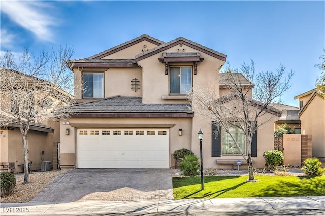 traditional home featuring a front yard, driveway, a garage, and stucco siding
