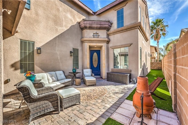 view of patio / terrace with an outdoor living space and a fenced backyard