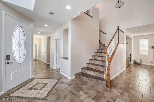 foyer entrance featuring visible vents, recessed lighting, stone finish flooring, baseboards, and stairway