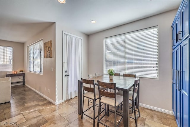 dining area featuring baseboards, recessed lighting, and stone finish flooring