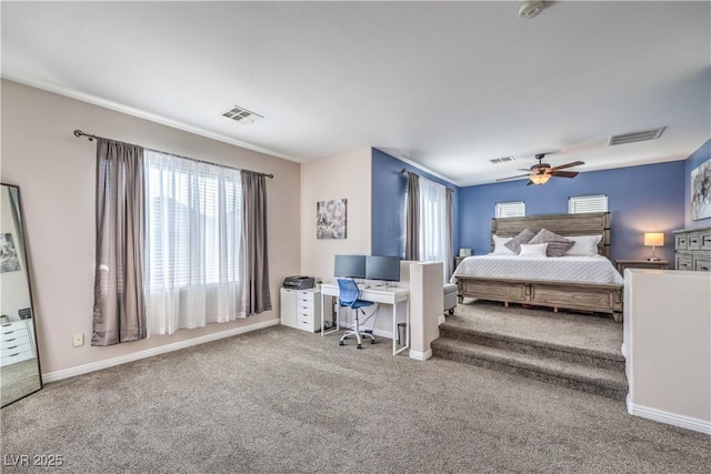 carpeted bedroom with visible vents, baseboards, and multiple windows