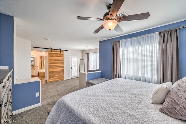 carpeted bedroom featuring a ceiling fan, a barn door, and baseboards