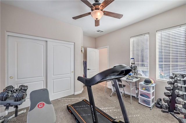 workout room with carpet, visible vents, ceiling fan, and baseboards