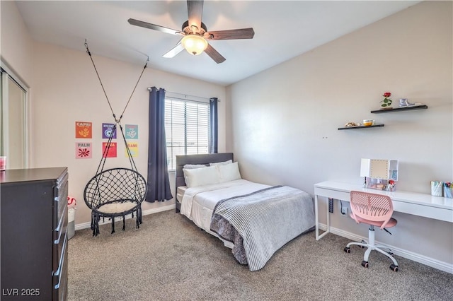carpeted bedroom with ceiling fan and baseboards