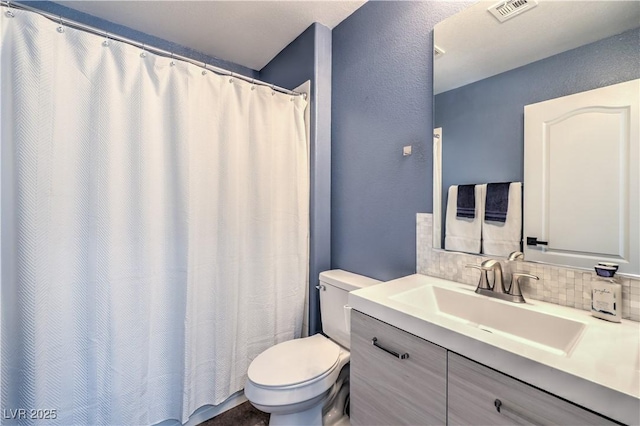 full bathroom featuring vanity, decorative backsplash, toilet, visible vents, and a textured wall