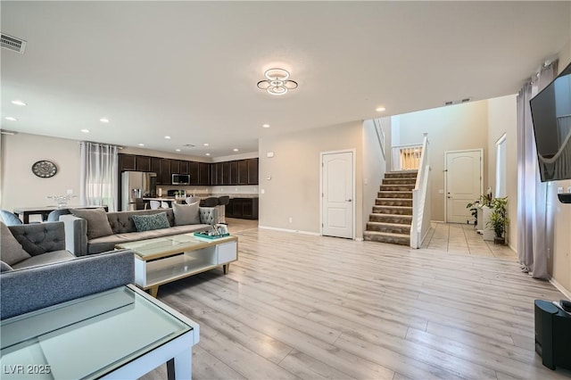 4902 Guysborough St, Las Vegas, NV 89148 - living room featuring stairway, light wood-type flooring, recessed lighting, and baseboards