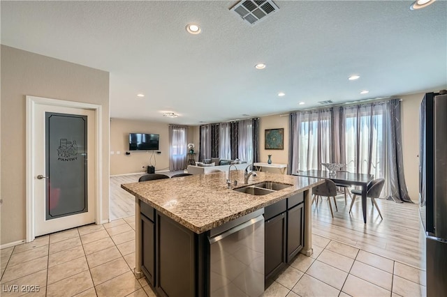 4902 Guysborough St, Las Vegas, NV 89148 - kitchen with a sink, appliances with stainless steel finishes, light tile patterned floors, an island with sink, and recessed lighting