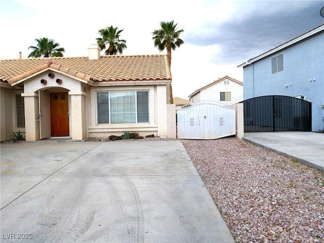 6508 Alpine Forest Ct, Las Vegas, NV 89149 - mediterranean / spanish-style house with a gate, a tile roof, and stucco siding