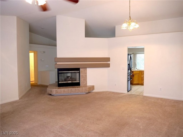 6508 Alpine Forest Ct, Las Vegas, NV 89149 - unfurnished living room with light colored carpet, a ceiling fan, vaulted ceiling, baseboards, and a tile fireplace