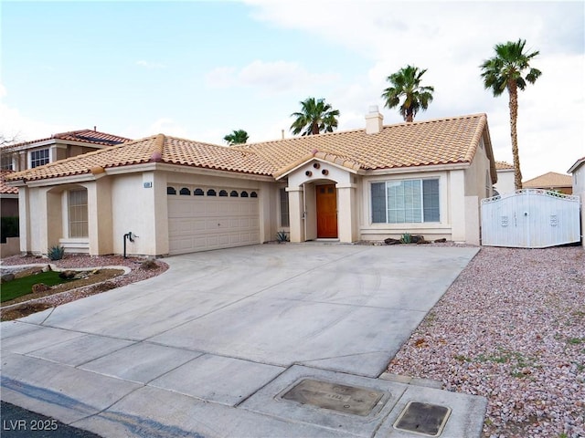 6508 Alpine Forest Ct, Las Vegas, NV 89149 - mediterranean / spanish house featuring stucco siding, a gate, a garage, a tiled roof, and driveway
