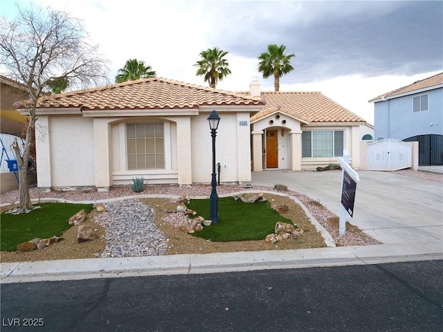 6508 Alpine Forest Ct, Las Vegas, NV 89149 - mediterranean / spanish-style home featuring a gate, a tile roof, and stucco siding