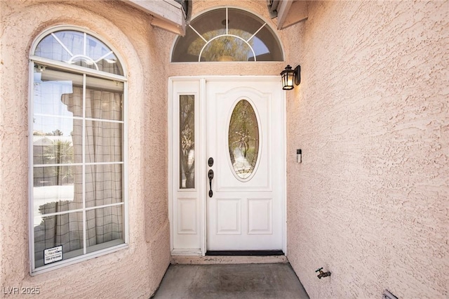 view of exterior entry featuring stucco siding